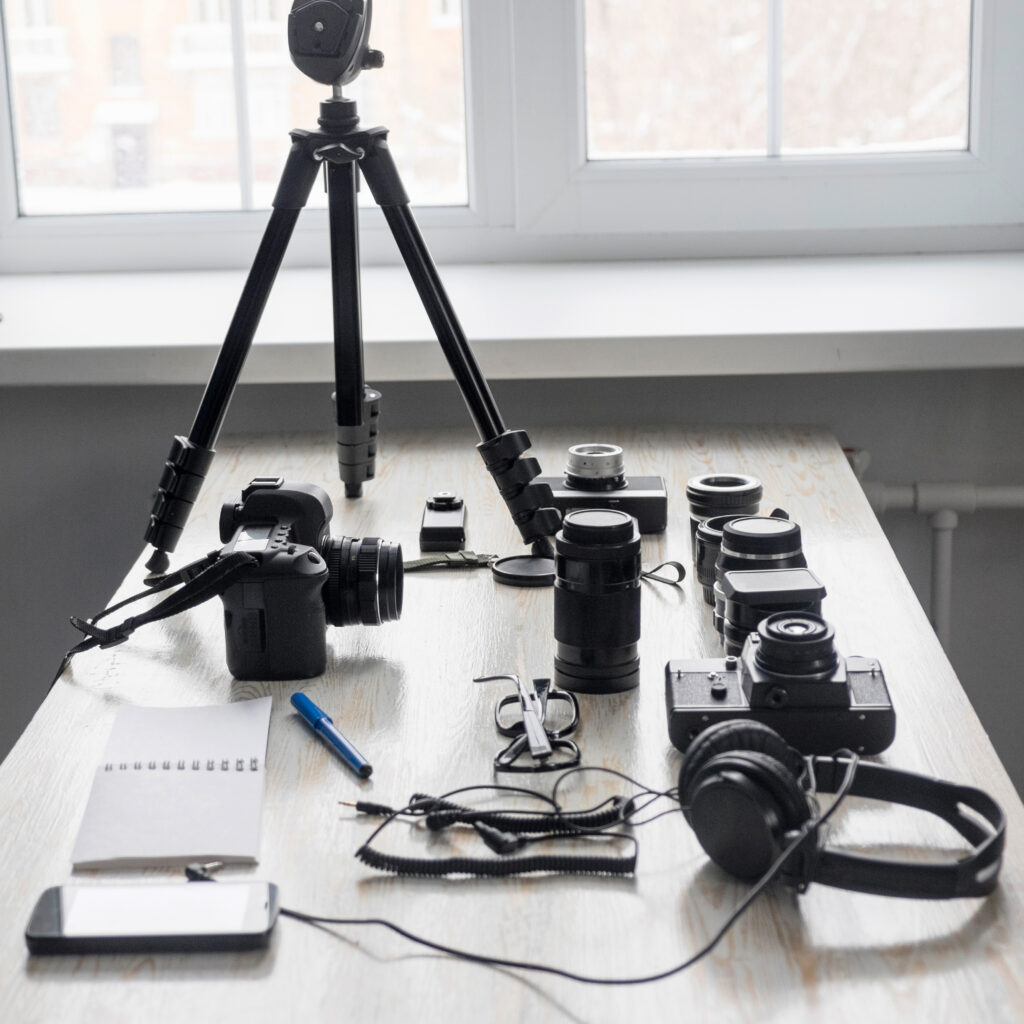 Smartphone and photography equipment on studio desk